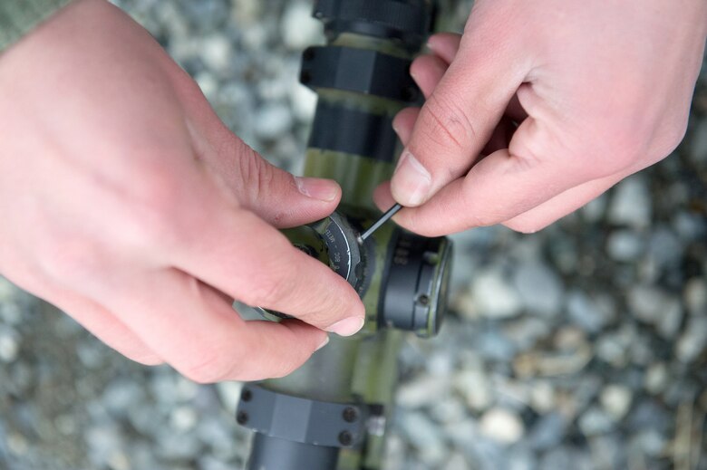 A paratrooper assigned to the 1st Squadron, 40th Cavalry Regiment (Airborne), 4th Infantry Brigade Combat Team (Airborne), 25th Infantry Division, U.S. Army Alaska, adjusts the scope on a M2010 Enhanced Sniper Rifle on Statler range at Joint Base Elmendorf-Richardson, Alaska, April 6, 2018, during marksmanship training.  A sniper's main responsibility is to deliver discriminatory, highly accurate rifle fire against enemy targets that cannot be engaged successfully by the regular rifleman due to range, size, location, fleeting nature, or visibility.