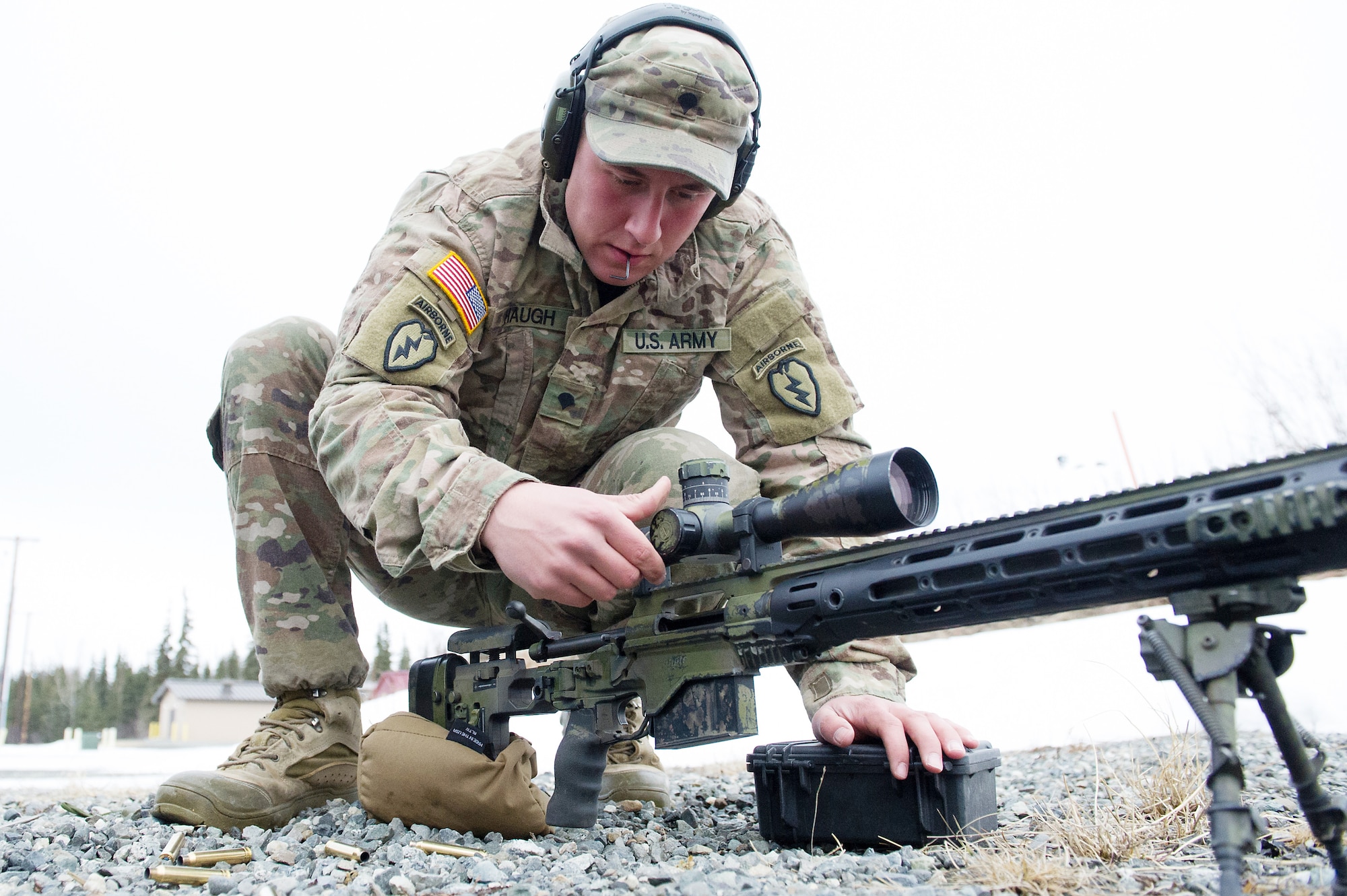 Army Spc. Eric Haugh, a native of Graham, Wash., assigned to Charlie Troop, 1st Squadron, 40th Cavalry Regiment (Airborne), 4th Infantry Brigade Combat Team (Airborne), 25th Infantry Division, U.S. Army Alaska, adjusts the scope on his M2010 Enhanced Sniper Rifle on Statler range at Joint Base Elmendorf-Richardson, Alaska, April 6, 2018, during marksmanship training.  A sniper's main responsibility is to deliver discriminatory, highly accurate rifle fire against enemy targets that cannot be engaged successfully by the regular rifleman due to range, size, location, fleeting nature, or visibility.