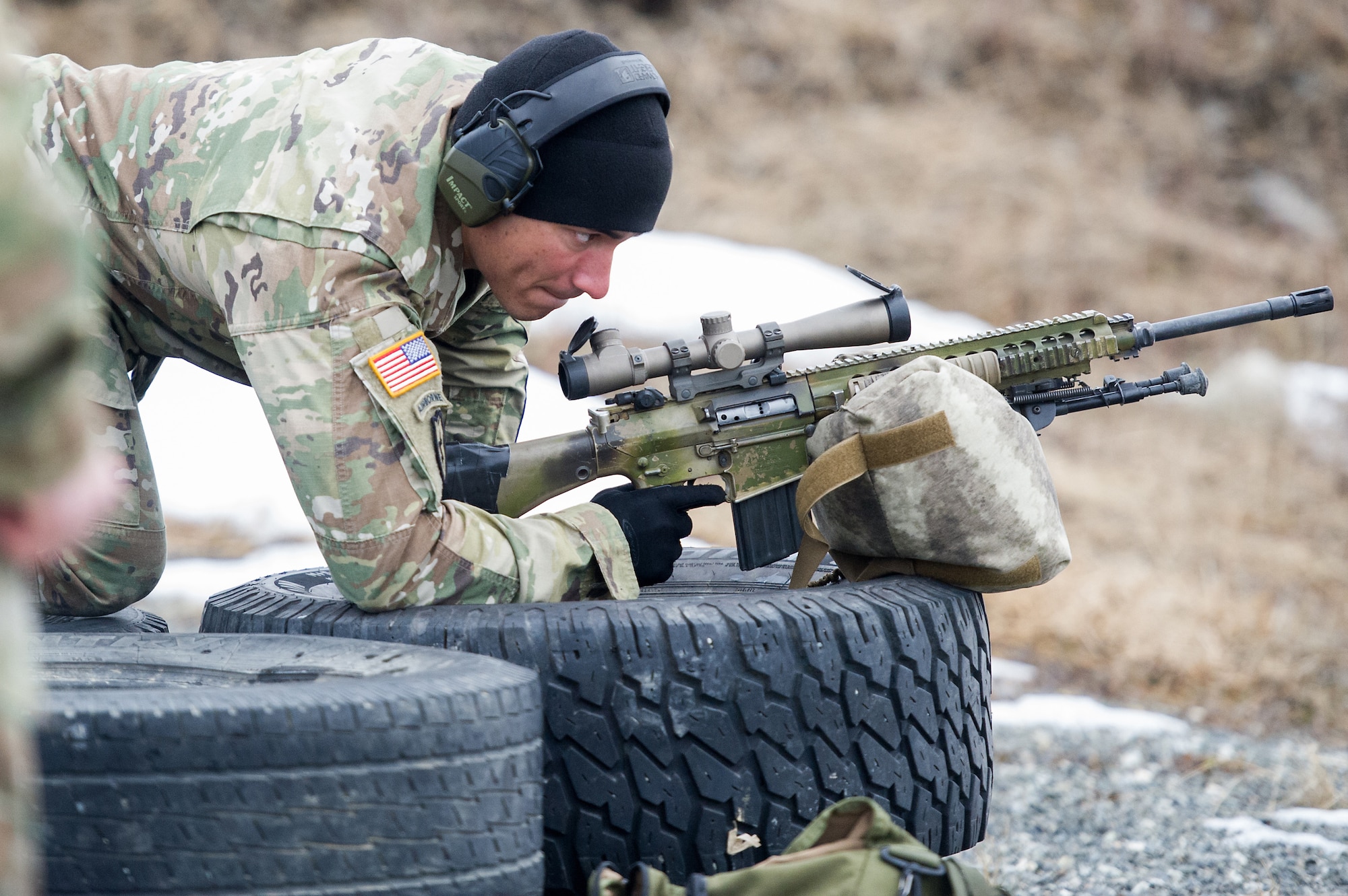 Army Spc. Arturo Dominguez, a native of Okeechobee, Fla., assigned to Charlie Troop, 1st Squadron, 40th Cavalry Regiment (Airborne), 4th Infantry Brigade Combat Team (Airborne), 25th Infantry Division, U.S. Army Alaska, gets in the prone position to fire a M110 Semi-Automatic Sniper System on Statler range at Joint Base Elmendorf-Richardson, Alaska, April 6, 2018, during marksmanship training.  A sniper's main responsibility is to deliver discriminatory, highly accurate rifle fire against enemy targets that cannot be engaged successfully by the regular rifleman due to range, size, location, fleeting nature, or visibility.