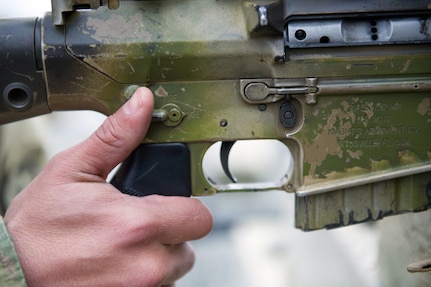 A paratrooper assigned to the 1st Squadron, 40th Cavalry Regiment (Airborne), 4th Infantry Brigade Combat Team (Airborne), 25th Infantry Division, U.S. Army Alaska, switches the selector lever from safe to fire on his M110 Semi-Automatic Sniper System on Statler range at Joint Base Elmendorf-Richardson, Alaska, April 6, 2018, during marksmanship training. A sniper's main responsibility is to deliver discriminatory, highly accurate rifle fire against enemy targets that cannot be engaged successfully by the regular rifleman due to range, size, location, fleeting nature, or visibility.