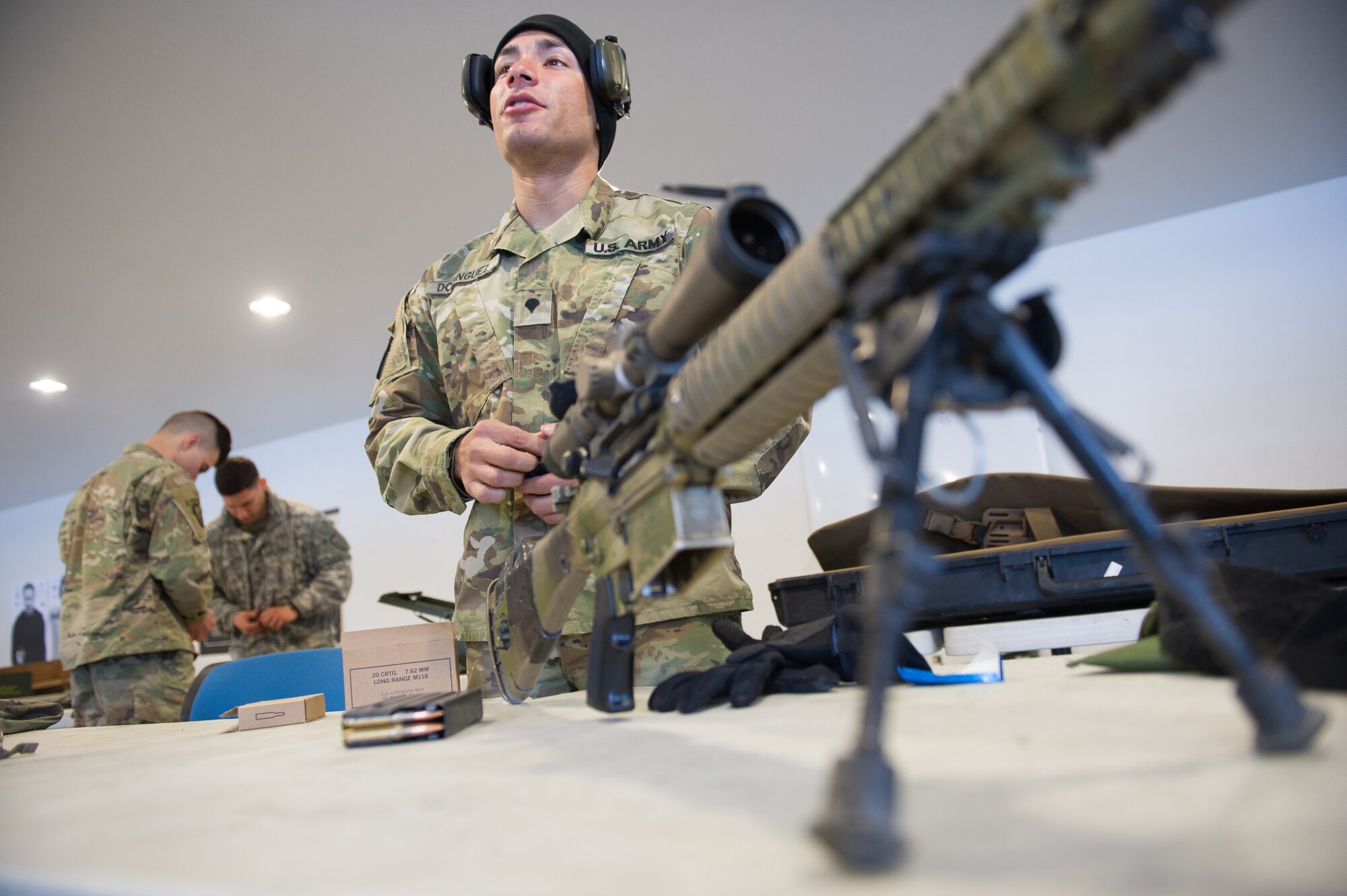 Army Spc. Arturo Dominguez, a native of Okeechobee, Fla., assigned to Charlie Troop, 1st Squadron, 40th Cavalry Regiment (Airborne), 4th Infantry Brigade Combat Team (Airborne), 25th Infantry Division, U.S. Army Alaska, loads ammunition into magazines before training with his M110 Semi-Automatic Sniper System on Statler range at Joint Base Elmendorf-Richardson, Alaska, April 6, 2018, during marksmanship training.  A sniper's main responsibility is to deliver discriminatory, highly accurate rifle fire against enemy targets that cannot be engaged successfully by the regular rifleman due to range, size, location, fleeting nature, or visibility.