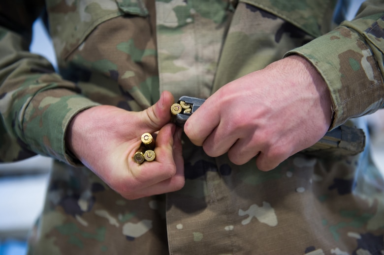 A paratrooper assigned to the 1st Squadron, 40th Cavalry Regiment (Airborne), 4th Infantry Brigade Combat Team (Airborne), 25th Infantry Division, U.S. Army Alaska, loads ammunition into a magazine before marksmanship training with M110 Semi-Automatic Sniper Systems and M2010 Enhanced Sniper Rifles on Statler range at Joint Base Elmendorf-Richardson, Alaska, April 6, 2018.  A sniper's main responsibility is to deliver discriminatory, highly accurate rifle fire against enemy targets that cannot be engaged successfully by the regular rifleman due to range, size, location, fleeting nature, or visibility.