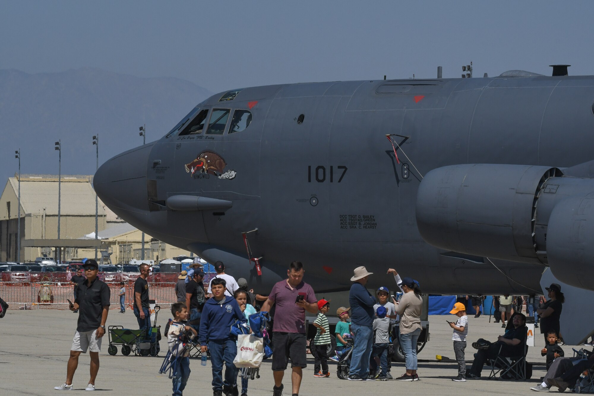 Crowds walk past a B-52 Stratofortress assigned to the 307th Bomb Wing after entering the show grounds of the March Field 2018 Air and Space Expo April 8, 2018.