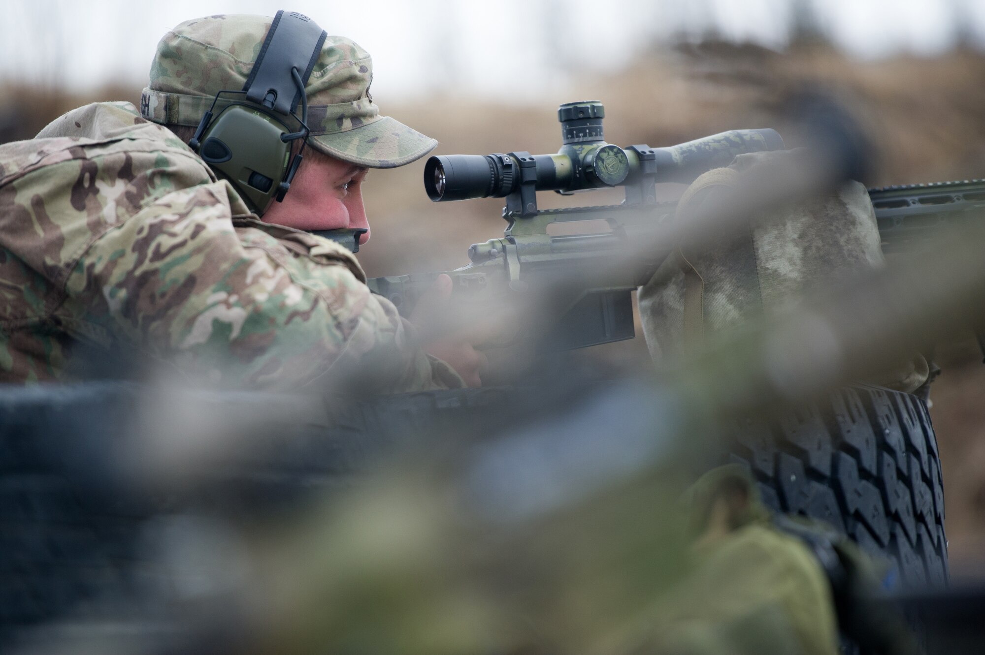 Army Spc. Eric Haugh, a native of Graham, Wash., assigned to Charlie Troop, 1st Squadron, 40th Cavalry Regiment (Airborne), 4th Infantry Brigade Combat Team (Airborne), 25th Infantry Division, U.S. Army Alaska, aims at a target with his M2010 Enhanced Sniper Rifle on Statler range at Joint Base Elmendorf-Richardson, Alaska, April 6, 2018, during marksmanship training.  A sniper's main responsibility is to deliver discriminatory, highly accurate rifle fire against enemy targets that cannot be engaged successfully by the regular rifleman due to range, size, location, fleeting nature, or visibility.