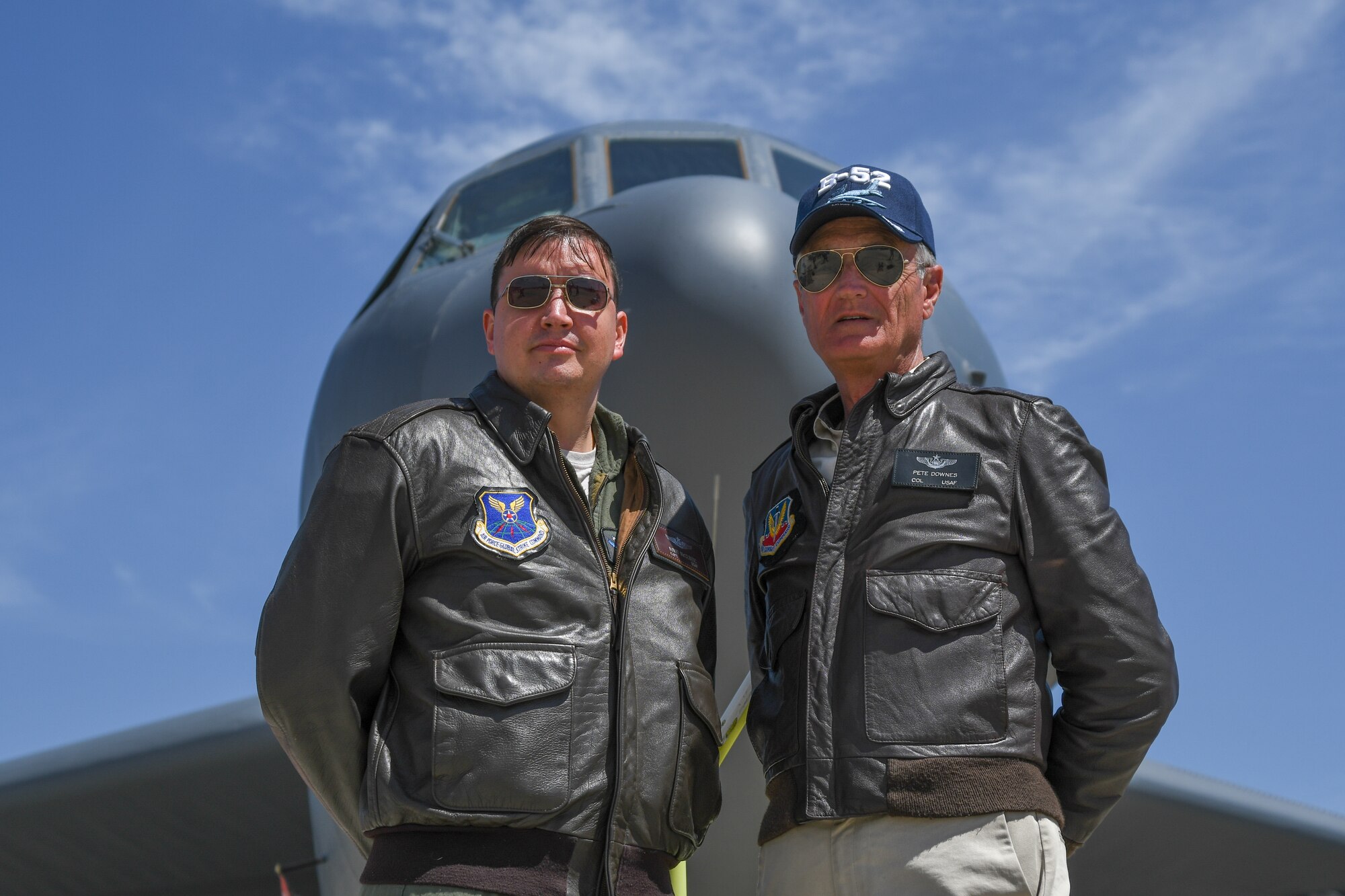 U.S. Air Force Maj. David McClintic, An electronic warfare officer assigned to the 11th Bomb Squadron, Barksdale Air Force Base, La. and retired Col. Pete Downes stand in front of a B-52 Stratofortress assigned to the 307th Bomb Wing durning the March Field 2018 Air and Space Expo April 8, 2018.