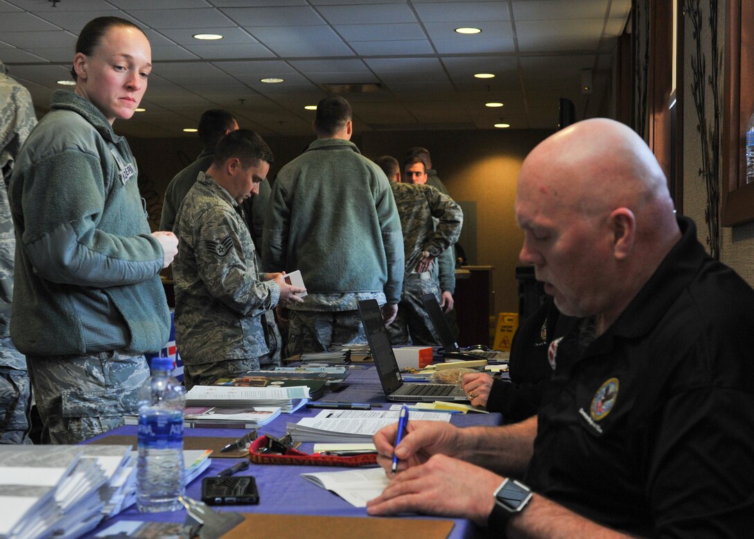 Staff Sgt. Brittany Canzoneri, a loadmaster with the 757th Airlift Squadron, asks Jackie Burlingame, a representative of the Veterans Administration (VA) about VA education benefits during a veteran resource fair at the Community Activity Center here, April 7, 2018.