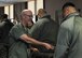 Tim Frazier, a registered nurse, hands out what he called door prizes to a lunch line of Airmen during a veteran resource fair at the Community Activity Center here, April 7, 2018.