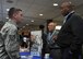 Douglas M. Babyak, a military liaison for Employer Support of the Guard and Reserve (ESGR), and Willie C. Lewis, a military outreach representative for ESGR, discuss VA employment help benefits with Staff Sgt. Steve Belfi, a fireteam member assigned to the 910th Security Forces Squadron during a veteran resource fair at the Community Activity Center here, April 7, 2018.