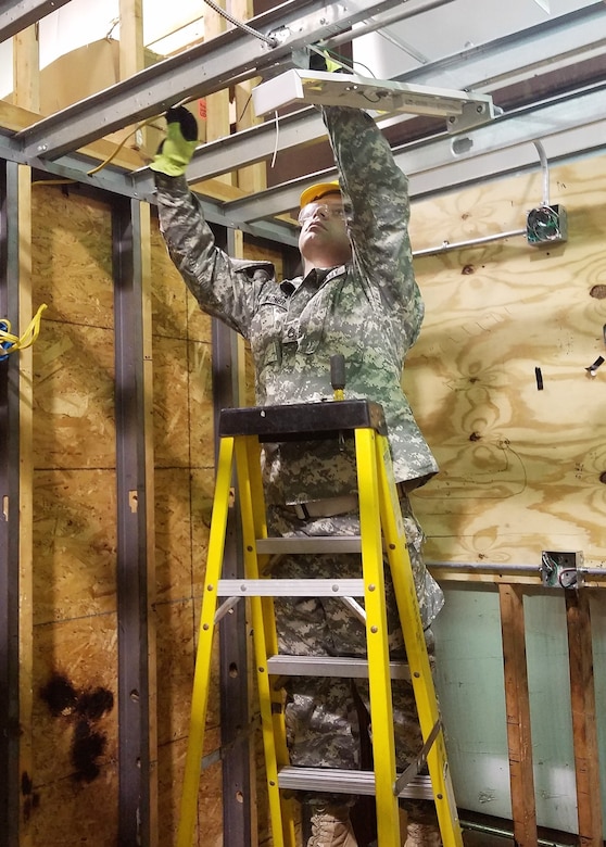An Army Reserve Soldier installs a light fixture during the 12R Interior Electrician course taught by instructors from the 80th Training Command and 102nd Training Division (Maneuver Support) at The Army School System Training Center Dix, New Jersey, March 29, 2018.