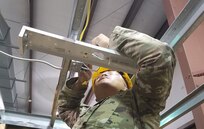 An Army National Guard Soldier learns how to install a light fixture during the 12R Interior Electrician course taught by instructors from the 80th Training Command and 102nd Training Division (Maneuver Support) at The Army School System Training Center Dix, New Jersey, March 29, 2018.