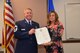 Chief Master Sgt. Edgar M. Kneupper, 74th Aerial Port Squadron operations superintendent, presented a certificate of appreciation to his wife, Michelle,  April, 7 2018 at his retirement ceremony on Joint Base San Antonio-Lackland, Texas.  In his civilian life, Kneupper is a fire fighter for the City of Austin, Texas.