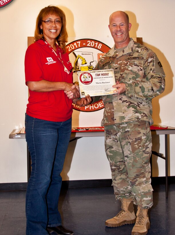 A certificate is presented to Maria Buckner, Honolulu District USACE by Col. Eric McFadden, RFO commander, for her work during the Northern California Wildfires Debris Removal Mission.
