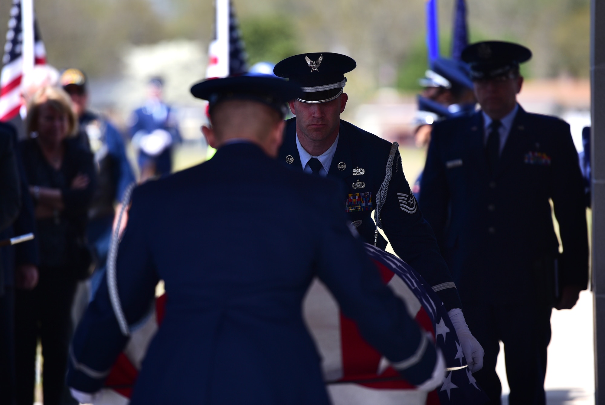 Seymour Johnson Air Force Base Honor Guardsmen prepare to fold a flag in honor of Col. Edgar Davis during his funeral ceremony April 6, 2018, Goldsboro, North Carolina. Davis served as an RF-4C Phantom navigator during the Vietnam War assigned to the 11th Tactical Reconnaissance Squadron. The unit exists today as the 11th Attack Squadron flying the MQ-9 Reaper. (U.S. Air Force photo by Senior Airman Christian Clausen)