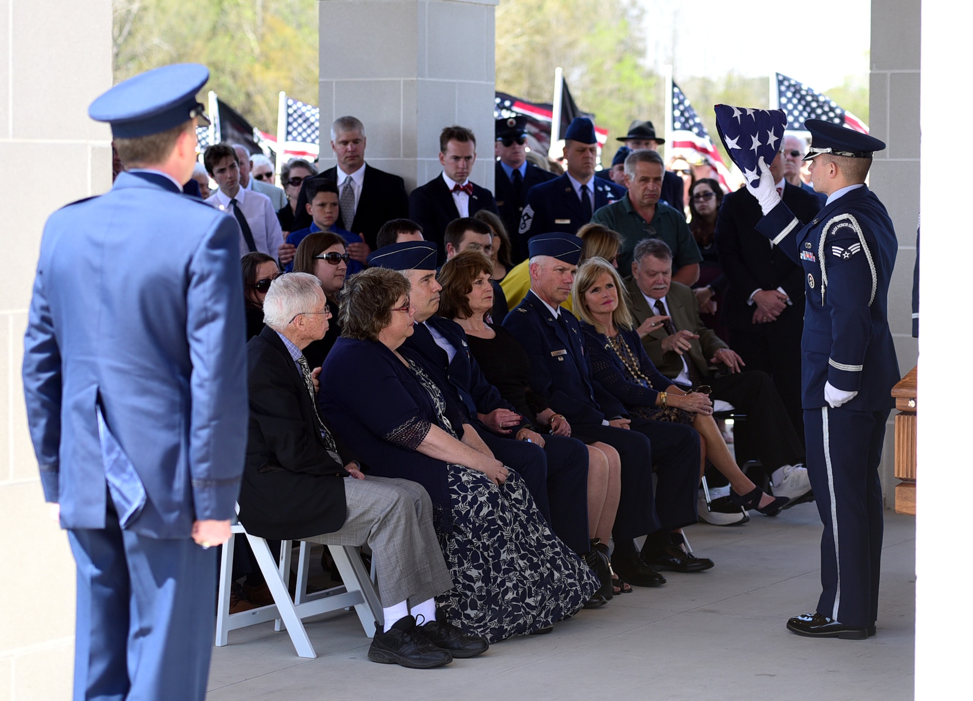 A Seymour Johnson Air Force Base Honor Guardsmen presents a flag in honor of Col. Edgar Davis during his funeral ceremony April 6, 2018, Goldsboro, North Carolina. Davis was shot down during a night photo-reconnaissance mission over Laos during the Vietnam War. After initial rescue efforts were unsuccessful, he was assumed dead and his remains stayed missing for 50 years. (U.S. Air Force photo by Senior Airman Christian Clausen)