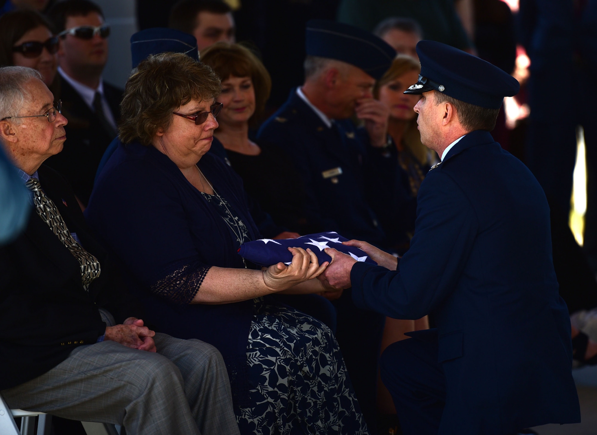 A Seymour Johnson Air Force Base Honor Guardsmen presents a flag in honor of Col. Edgar Davis to his daughter, Martha Morton, during his funeral ceremony April 6, 2018, Goldsboro, North Carolina. Davis was shot down during a night photo-reconnaissance mission over Laos during the Vietnam War. After initial rescue efforts were unsuccessful, he was assumed dead and his remains stayed missing for 50 years. (U.S. Air Force photo by Senior Airman Christian Clausen)