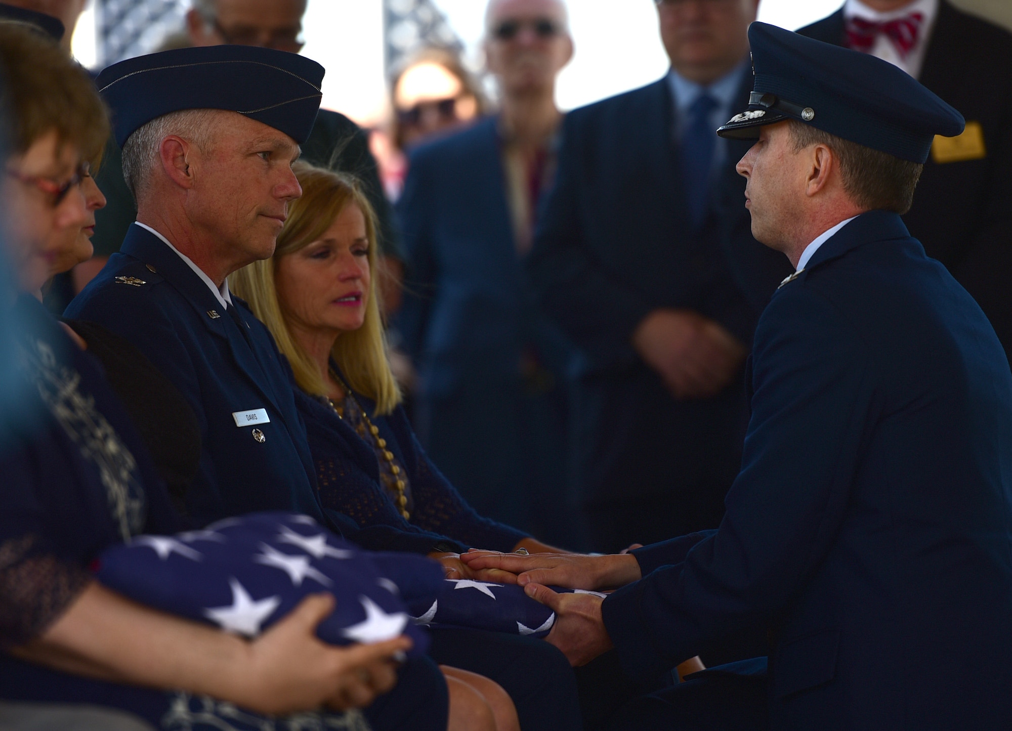 A Seymour Johnson Air Force Base Honor Guardsman presents a flag in honor of Col. Edgar Davis to his son Col. Alan Davis during his funeral ceremony April 6, 2018, Goldsboro, North Carolina. After being shot down over Laos during the Vietnam War in 1968, a Laotian villager buried the remains. In 2015, the villager’s son reached out regarding the location of the remains. The Defense POW/MIA Accounting Agency recovered Davis’ remains in 2017. (U.S. Air Force photo by Senior Airman Christian Clausen)