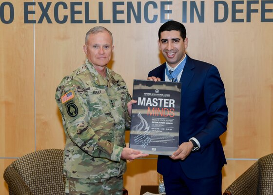 DIA Director Army Lt. Gen. Robert Ashley presents Medal of Honor recipient retired Army Capt. Florent Groberg with a token of appreciation.