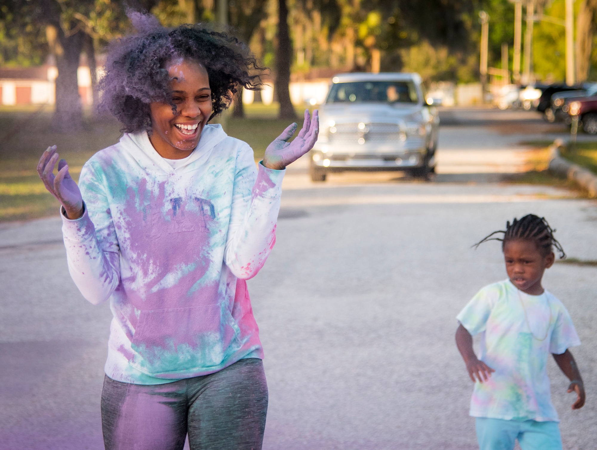 A runner reacts to getting purple chalk in her hair during a Color Run 5k at Eglin Air Force Base, Fla., April 6, 2018. The 5k was to promote Sexual Assault Awareness and Prevention Month. (U.S. Air Force photo by Samuel King Jr.)