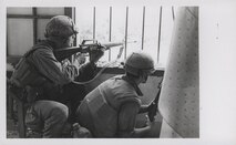 Marines A Company, 1st Battalion, 1st Marines [A/1/1] return fire from a house window during a search and clear mission in the battle of Hue, February 1968. (official USMC photo by Sergeant Bruce A. Atwell, Marine Corps Archives & Special Collections).