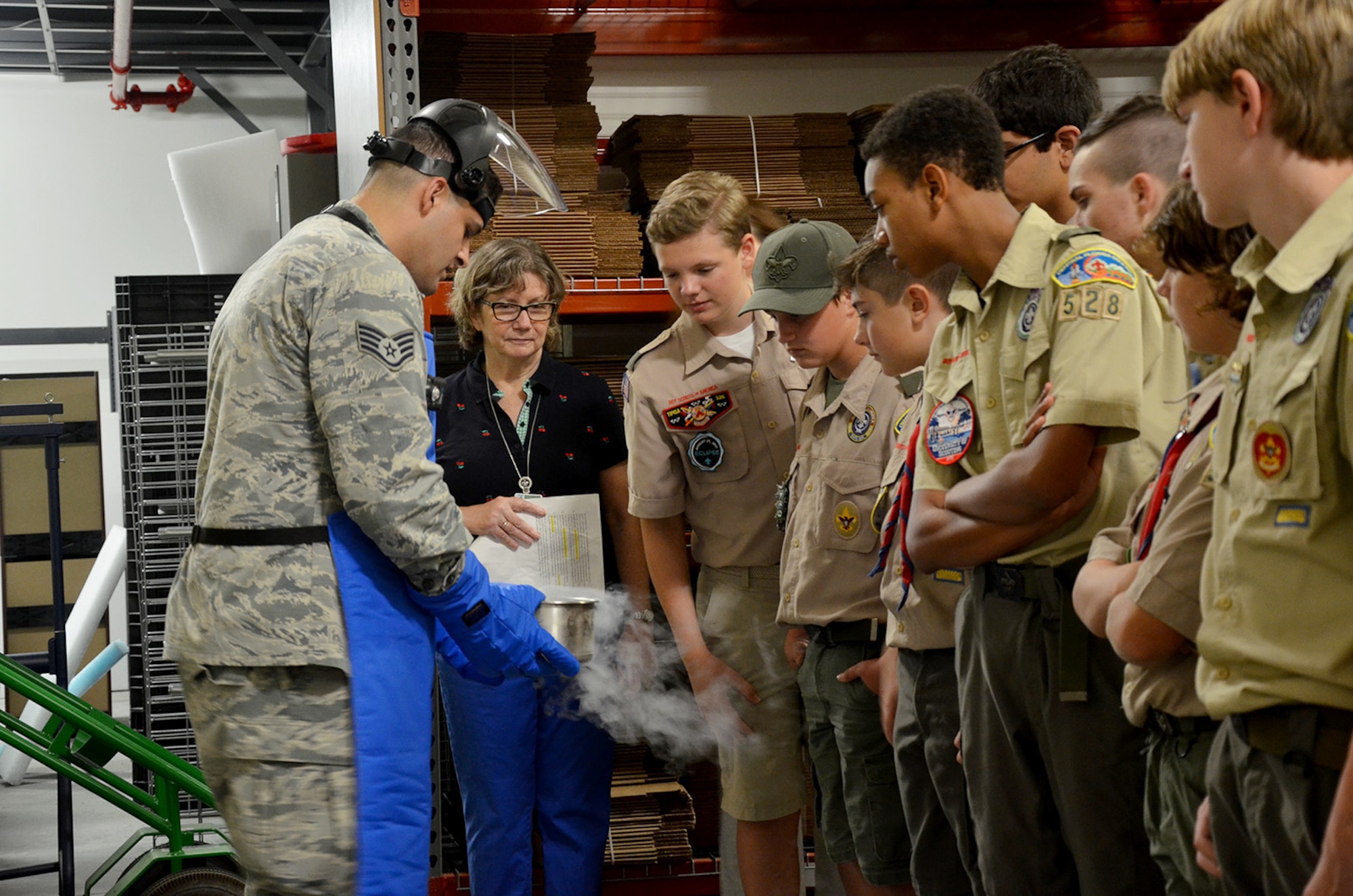 Staff Sgt. Leland La Kemper, a radiochemistry lab technician at the Air Force Radiochemistry Laboratory, Patrick AFB, Fla., shows a group of Boy Scouts the effects of liquid nitrogen.  La Kemper was one of several Airmen who volunteered to help scouts from across Central Florida earn their Nuclear Science Merit Badge March 31, 2018.  (U.S. Air Force photo by Susan A. Romano)