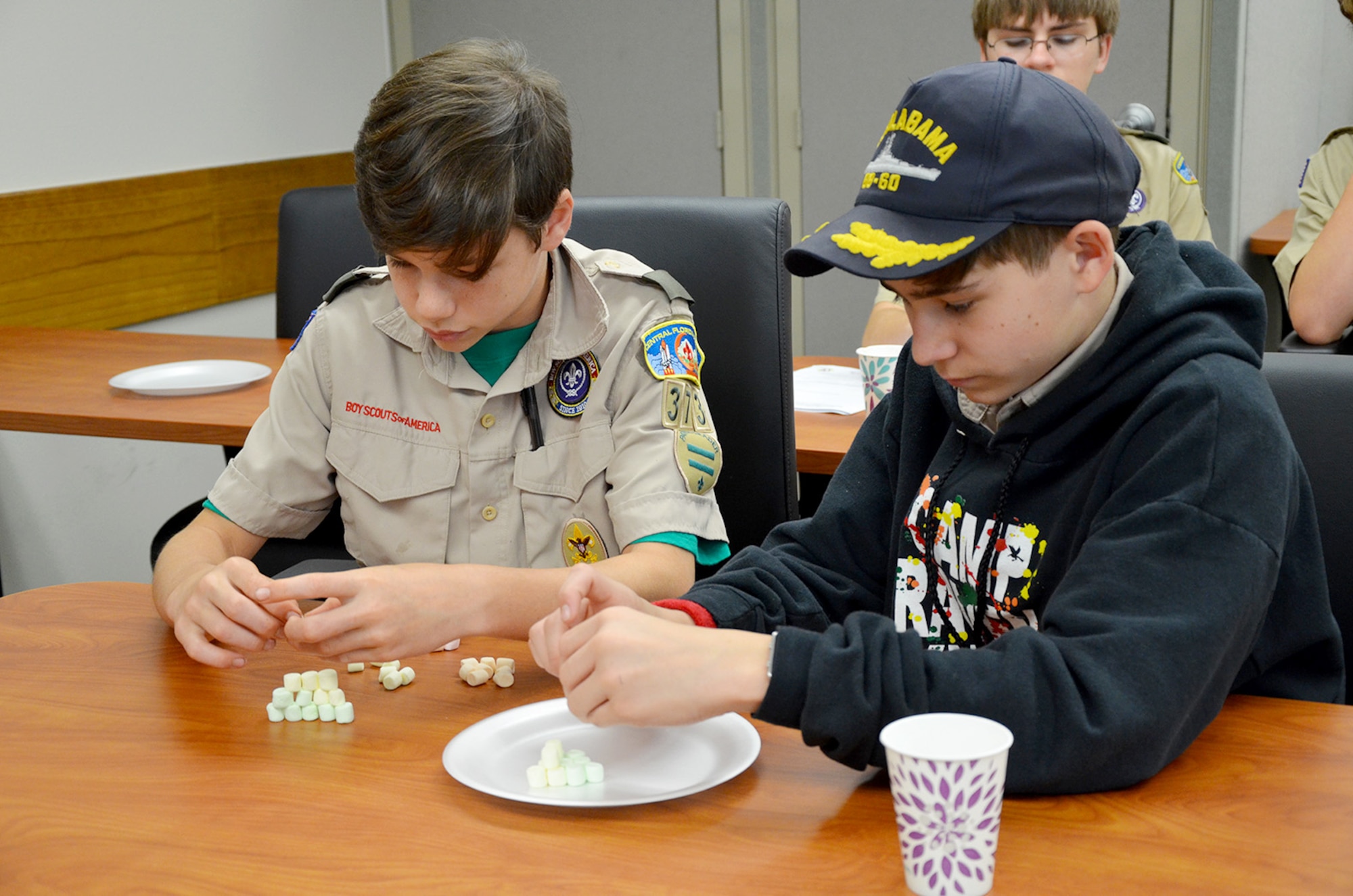 Robbie Naberhaus (left) and Jack Gander, both 8th graders at Ascension Catholic School and members of Boy Scout Troop #373 in Melbourne, Fla., attempt to build an atomic model using miniature marshmallows during an event hosted by the Air Force Technical Applications Center, Patrick AFB, Fla., March 31, 2018.  The boys were two of 98 scouts who traveled to the base to earn their Nuclear Science Merit Badge with the help of Airmen from the Department of Defense’s sole nuclear treaty monitoring center.  (U.S. Air Force photo by Susan A. Romano)