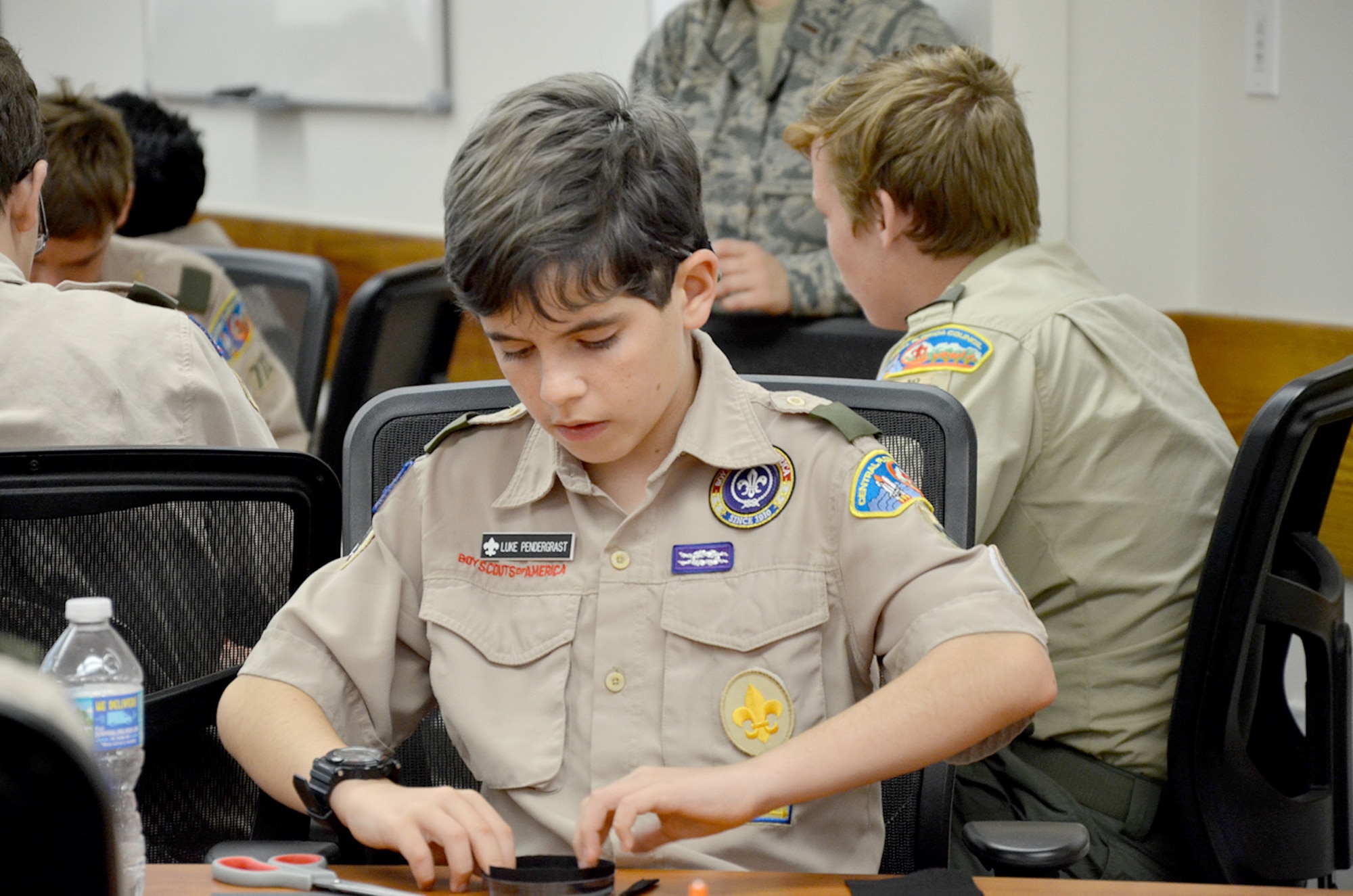Luke Pendergrast, a Boy Scout from Troop 330 in Ormond Beach, Fla., carefully molds black felt in a petri dish to create a cloud chamber to visualize condensation trails left by ionizing radiation.  Pendergrast attended the Nuclear Science Merit Badge event hosted by the Air Force Technical Applications Center, Patrick AFB, Fla,. March 31, 2018.  (U.S. Air Force photo by Susan A. Romano)