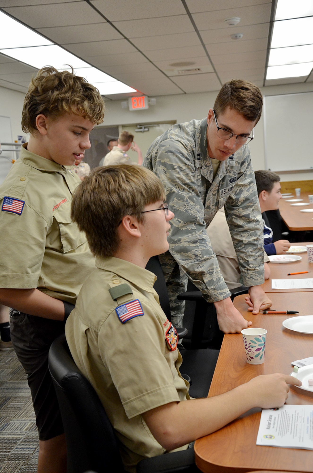 Capt. Jason Goins, a scientist with the Air Force Technical Applications Center, helps Boy Scouts Daniel Kirchhof, a 9th grader at University High School in Orlando, and Ethan Jesse, an 8th grader from Innovation Middle School in Orlando, during a Boy Scout Merit event hosted by the nuclear treaty monitoring center at Patrick AFB, Fla., March 31, 2018.  Goins was one of several Airmen from AFTAC who volunteered to help troops earn the badge.  (U.S. Air Force photo by Susan A. Romano)