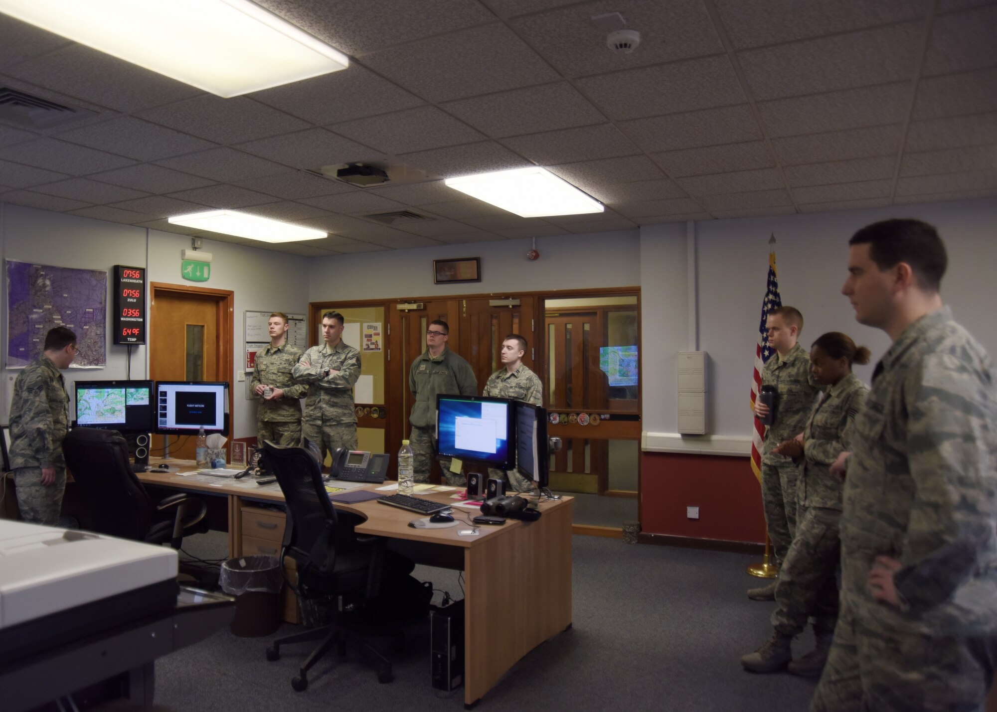 A 48th Operations Support Squadron weather forecaster journeyman, left, briefs his office on the weather conditions for the day at Royal Air Force Lakenheath, England, March 20. At each shift change, the outgoing forecaster briefs the incoming Airmen on what weather to expect for the day. The 48th OSS weather flight keeps aircrews constantly apprised of the weather conditions, keeping them safe in the air and allowing them to complete the Liberty Wing mission. (U.S. Air Force photo/Senior Airman Abby L. Finkel)