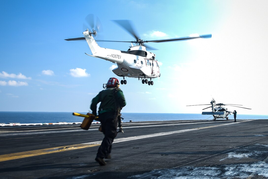 An SA-330 Puma helicopter approaches the flight deck.