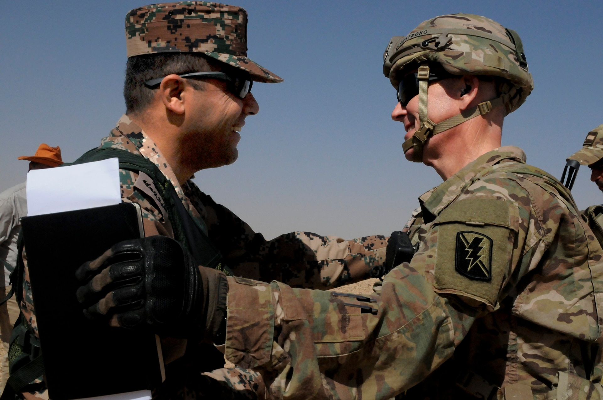 Lt. Col. Zakarea I. Al Ababneh, the commander of the Jordan Armed Forces 11th Border Guard greets U.S. Army Lt. Col. Joel Armstrong, commander, 1st Battalion, 184th Infantry Regiment, during a 60 mm mortar live fire exercise outside of Amman, Jordan, April 4, 2018.