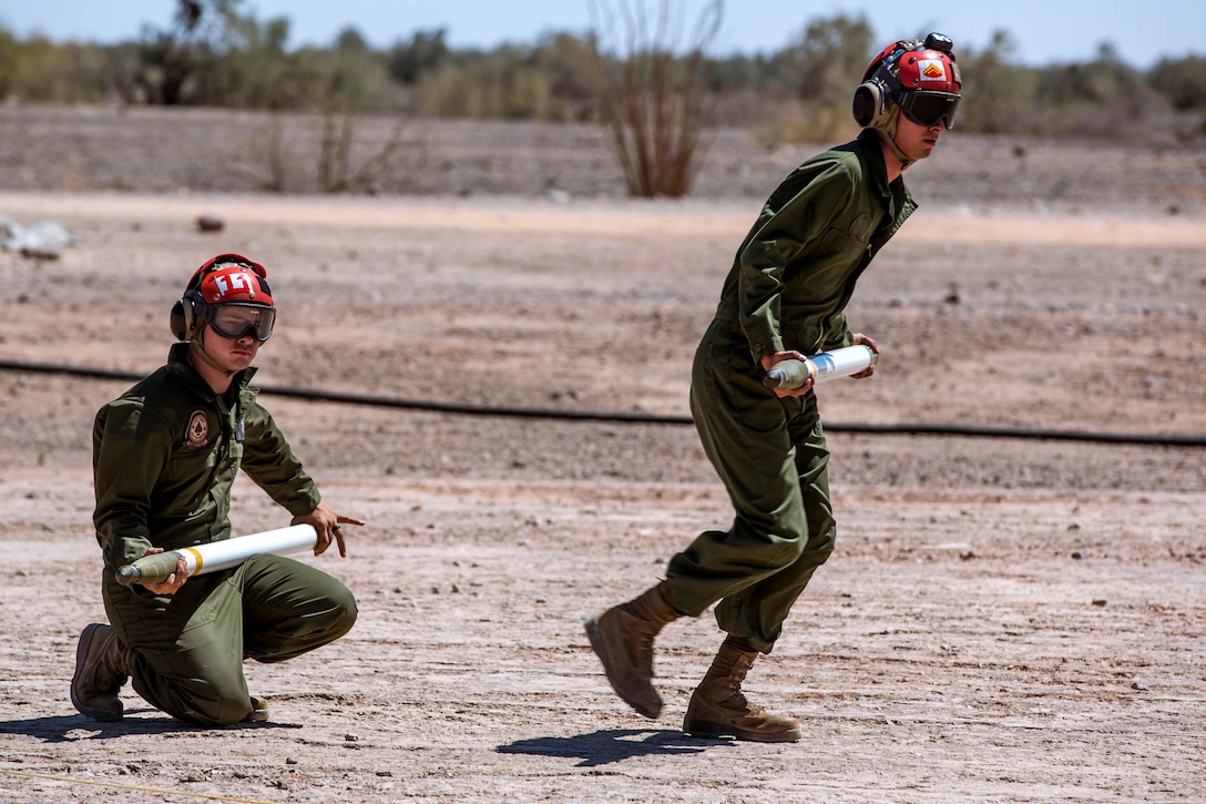 Marines prepare to arm a UH-1Y Venom helicopter.