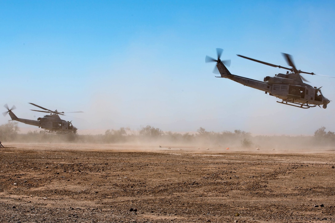 Two Marine Corps UH-1Y Venom helicopters take off.