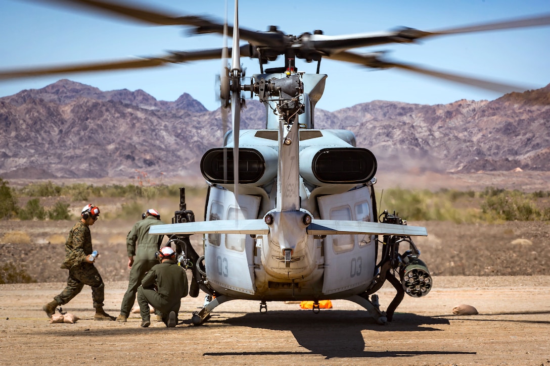 Marines arm a UH-1Y Venom helicopter.