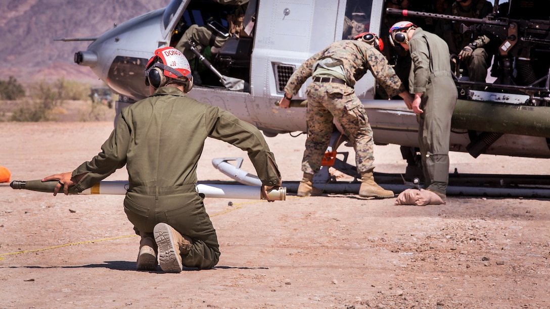 Marines arm a UH-1Y Venom helicopter.