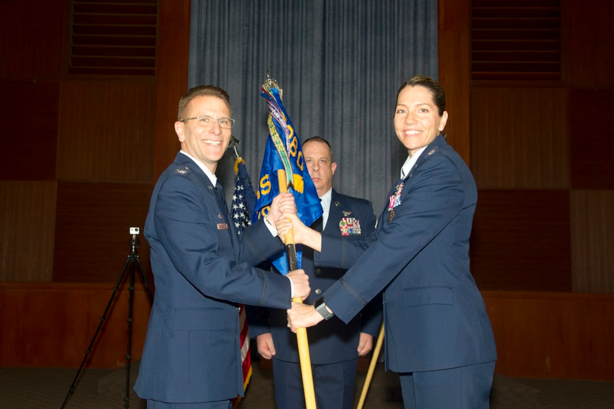 Lt. Col. Karyn L. Christen passes the 13th Reconnaissance Squadron guidon to Col. David S. Edwards, 726th Operations Group commander at Creech Air Force Base, Nevada, as she relinquishes command April 7 at Beale AFB, California.
