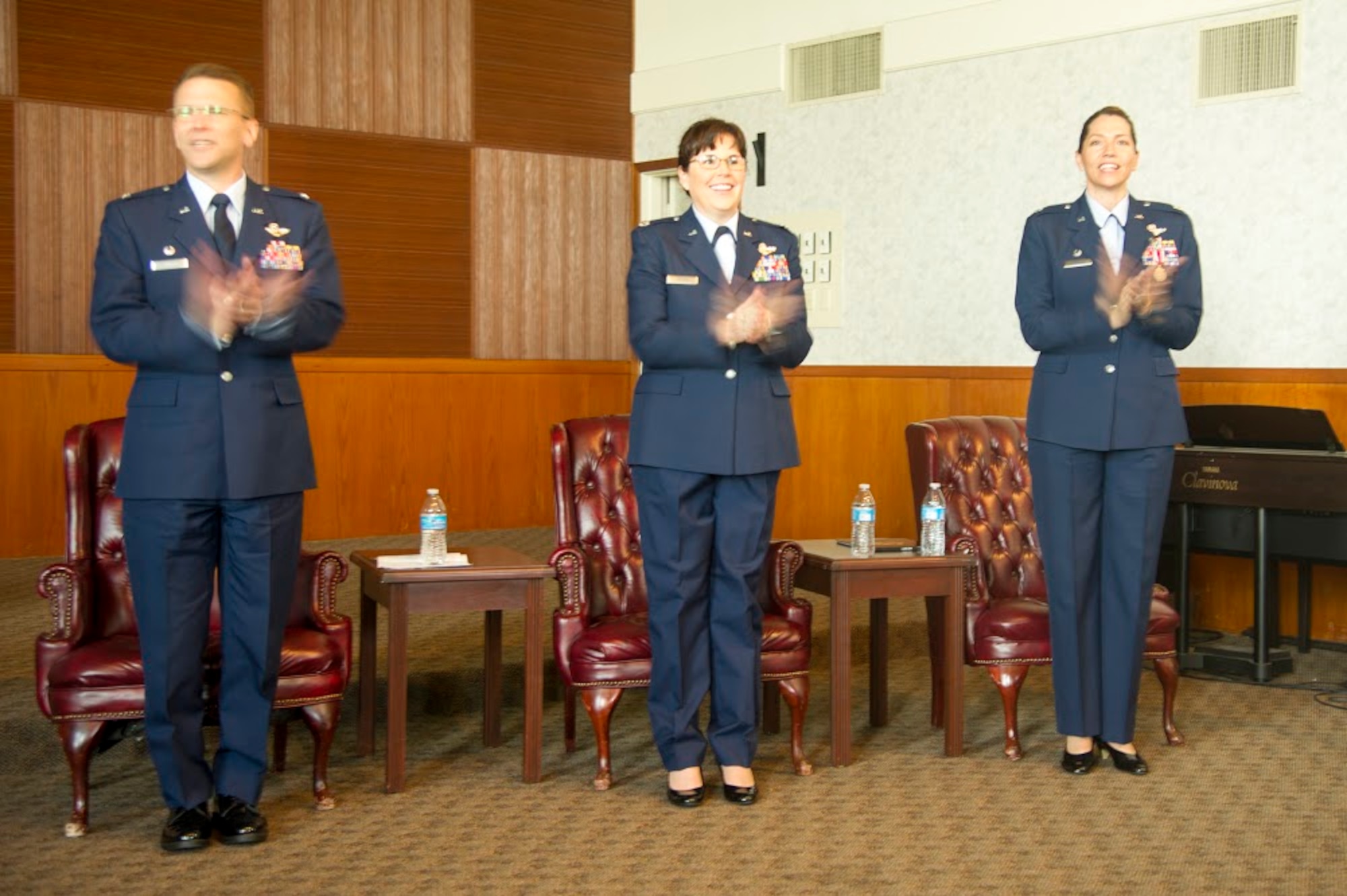 (Left to right) Col. David S. Edwards, 726th Operations Group commander at Creech Air Force Base, Nevada; Lt. Col. Summer A. Fields, 13th Reconnaissance Squadron commander; and Lt. Col. Karyn L. Christen, 726th OG deputy commander, sing and clap to the Air Force song April 7 at Beale Air Force Base, California.
