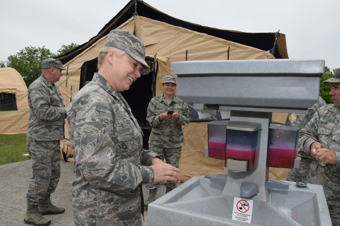 Maj. Robin Ecks, 433rd Force Support Squadron commander, washes her hands prior to eating lunch from a Single Pallet Expeditionary Kitchen April 7, 2018 on Joint Base San Antonio-Lackland, Texas. Ecks accompanied leadership for the noonday meal that served nearly 50 Airmen. (U.S. Air Force photo by Tech Sgt. Carlos J. Treviño)