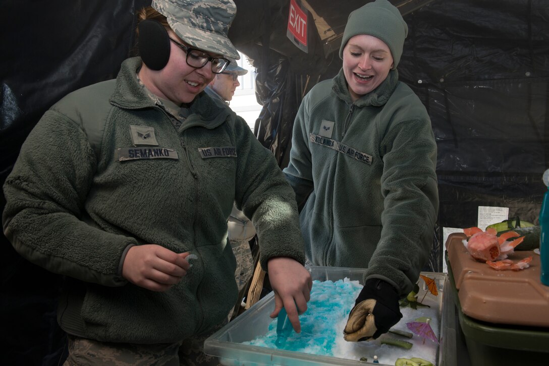 Senior Airmen Racheal Semanko (left) and Sarah Kolanda add some color to the food display at the SPEK kitchen during the April UTA. (Air Force Photo/Staff Sgt. Amber Jacobs)