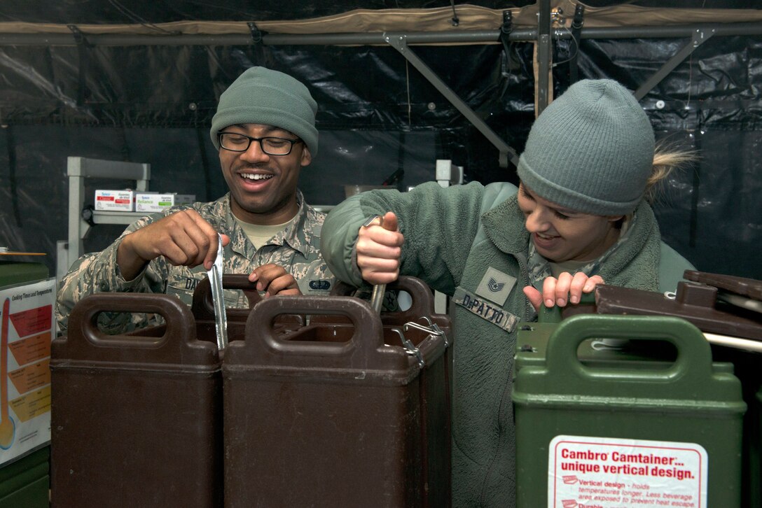 Airman 1st Class Darnell Davis (left) and Tech. Sgt. Lauren DePatto prepare for the lunch crowd to arrive at the SPEK kitchen during the April UTA. (Air Force Photo/Staff Sgt. Amber Jacobs)