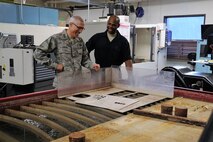Master Sgt. Tony Shaw, the 302nd Maintenance Squadron metals technologies chief, explains how the squadron’s water jet cutting center works to Maj. Gen. Craig La Fave, the 22nd Air Force commander, during his tour of the 302nd Airlift Wing’s maintenance facilities at Peterson Air Force Base, Colorado, April 8, 2018. La Fave spent part of the morning learning about the squadron’s challenges and accomplishments. (U.S. Air Force photo by Staff Sgt. Frank Casciotta)