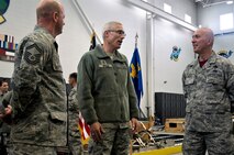 Maj. Gen. Craig La Fave, 22nd Air Force commander, speaks with Senior Master Sgts. Augusto Goncalves (right) and Robert Gage (left), both with the 39th Aerial Port Squadron, April 7, 2018 at Peterson Air Force Base, Colorado. La Fave visited the 302nd Airlift Wing to see its mission firsthand and to talk with Reserve Citizen Airmen at their units. (U.S. Air Force photo by Staff Sgt. Justin Norton)