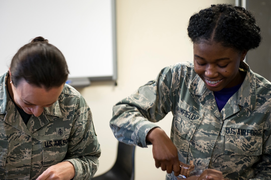 Master Sgt. Amanda Lewis, left, 23d Aerospace Medicine Squadron (AMDS) public health flight chief, and Airman 1st Class Angel Brumfield, 23d AMDS public health technician, open their meals, ready to eat (MREs) during an MRE open-package inspection, April 6, 2018, at Moody Air Force Base, Ga. Airmen from Public Health examine the MREs for defects and overall quality and determine whether they’ll be utilized here, at other bases or to condemn the batch. Public Health monitors more than 8,400 MREs yearly to ensure they are safe and fit for consumption, so as to maintain a healthy fighting force. (U.S. Air Force photo by Airman 1st Class Erick Requadt)