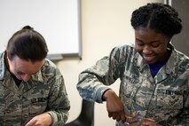 Master Sgt. Amanda Lewis, left, 23d Aerospace Medicine Squadron (AMDS) public health flight chief, and Airman 1st Class Angel Brumfield, 23d AMDS public health technician, open their meals, ready to eat (MREs) during an MRE open-package inspection, April 6, 2018, at Moody Air Force Base, Ga. Airmen from Public Health examine the MREs for defects and overall quality and determine whether they’ll be utilized here, at other bases or to condemn the batch. Public Health monitors more than 8,400 MREs yearly to ensure they are safe and fit for consumption, so as to maintain a healthy fighting force. (U.S. Air Force photo by Airman 1st Class Erick Requadt)