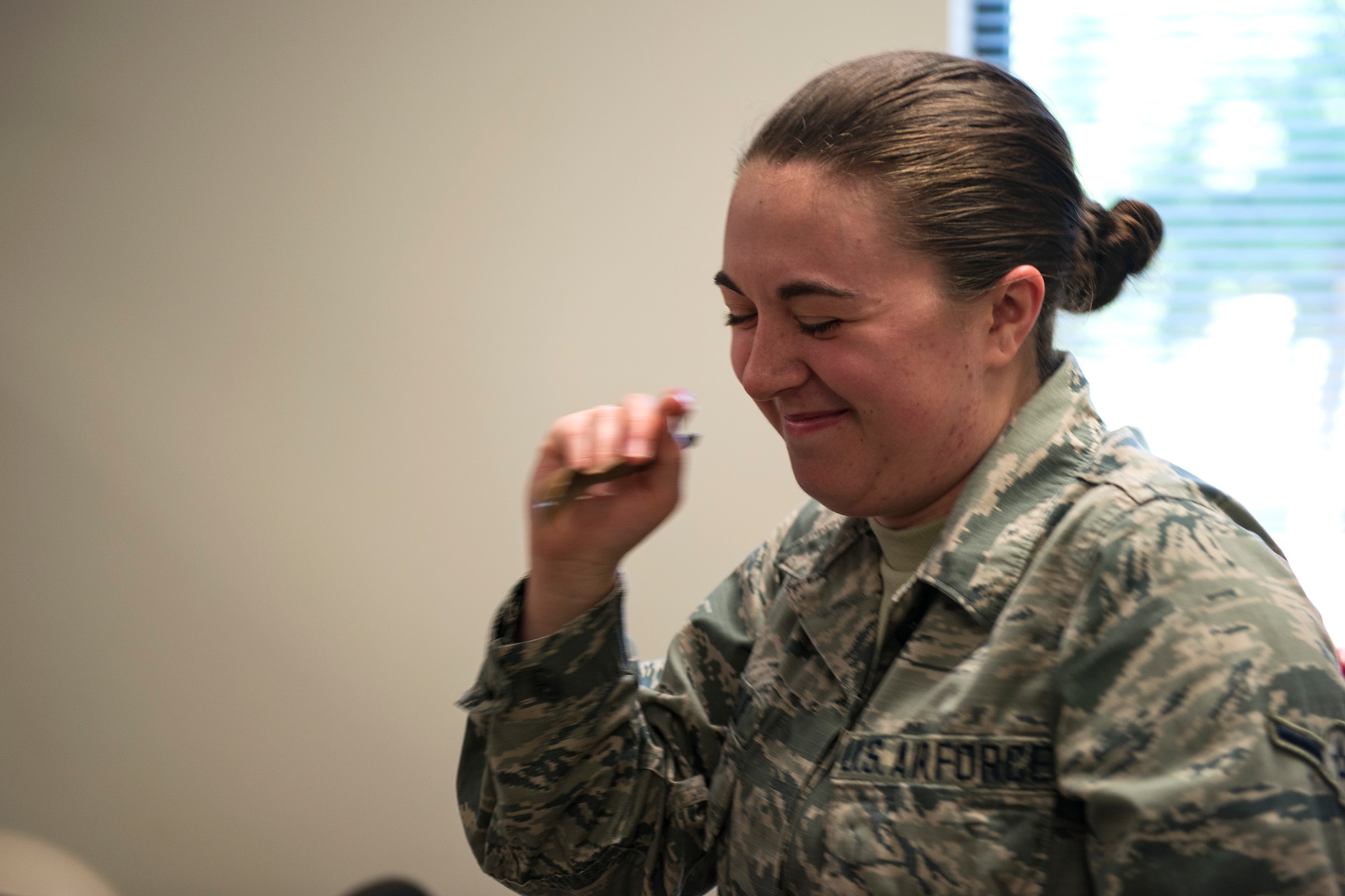 Airman McKenzie Daigle, 23d Aerospace Medicine Squadron public health technician, consumes a meal, ready to eat (MRE) during an MRE open-package inspection, April 6, 2018, at Moody Air Force Base, Ga. Airmen from Public Health examine the MREs for defects and overall quality and determine whether they’ll be utilized here, at other bases or to condemn the batch. Public Health monitors more than 8,400 MREs yearly to ensure they are safe and fit for consumption, so as to maintain a healthy fighting force. (U.S. Air Force photo by Airman 1st Class Erick Requadt)