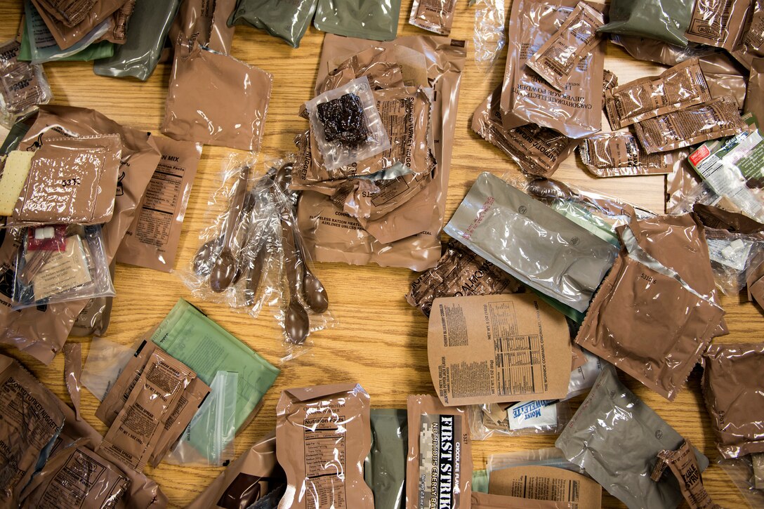 Meals, ready to eat (MREs) rest on a table during an MRE open-package inspection, April 6, 2018, at Moody Air Force Base, Ga. Airmen from Public Health examine the MREs for defects and overall quality and determine whether they’ll be utilized here, at other bases or to condemn the batch. Public Health monitors more than 8,400 MREs yearly to ensure they are safe and fit for consumption, so as to maintain a healthy fighting force. (U.S. Air Force photo by Airman 1st Class Erick Requadt)