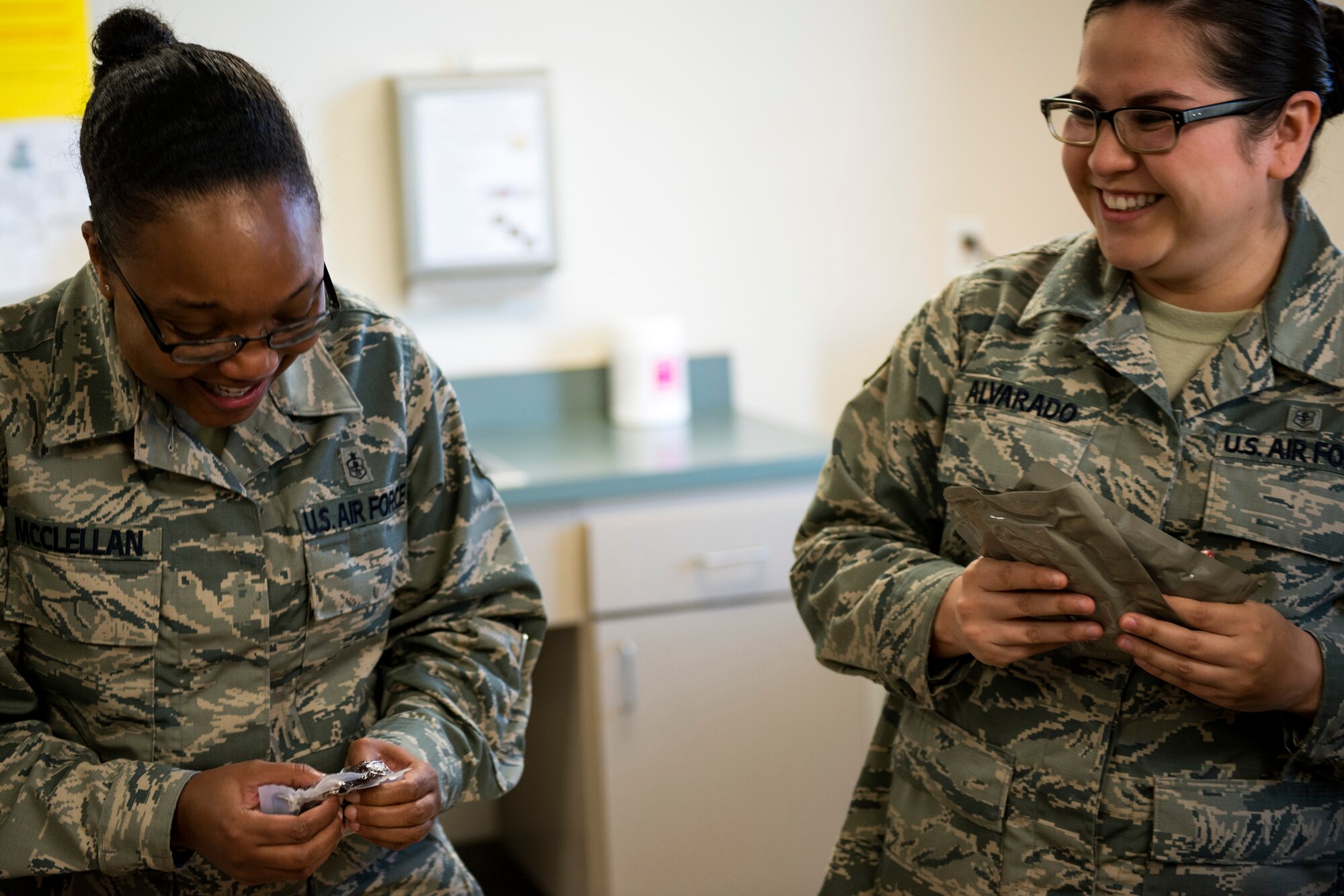 Staff Sgt. Jasmine McClellan, left, 23d Aerospace Medicine Squadron (AMDS) Public Health Flight NCO in charge of deployment medicine, and Senior Airman Evelyn Alvarado, 23d AMDS Public Health Flight meal, ready to eat (MRE) program manager, examine the content on their MREs during an MRE open-package inspection, April 6, 2018, at Moody Air Force Base, Ga. Airmen from Public Health examine the MREs for defects and overall quality and determine whether they’ll be utilized here, at other bases or to condemn the batch. Public Health monitors more than 8,400 MREs yearly to ensure they are safe and fit for consumption, so as to maintain a healthy fighting force. (U.S. Air Force photo by Airman 1st Class Erick Requadt)