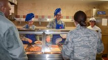 Maj. Gen. Craig La Fave, the 22nd Air Force commander, and Chief Master Sgt. Imelda Johnson, the 22nd AF command chief, serve lunch to 302nd Airlift Wing reservists at Peterson Air Force Base, Colorado, April 7, 2018. La Fave and Johnson visited 302nd Airlift Wing for a firsthand look at the mission. (U.S. Air Force photo by Maj. Jolene Bottor-Ortiona)