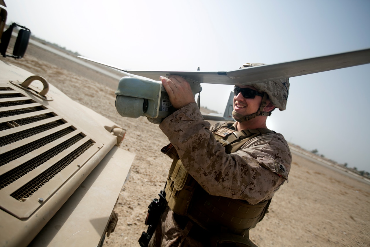 Marine Corps Sgt. John Verhage III aids in the employment of remote sensor systems and unmanned aerial surveillance assets to help detect the movement of enemy personnel and vehicles prior to a sensor emplacement mission near Bost Airfield, Afghanistan.