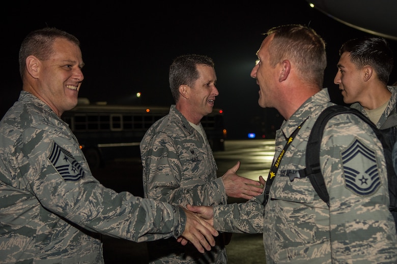 Col. Christopher Sage, 4th Fighter Wing commander, and Chief Master Sgt. William Adams, 4th FW command chief, greet Airmen from the 4th FW as they return home from deployment, April 9, 2018, at Seymour Johnson Air Force Base, North Carolina.