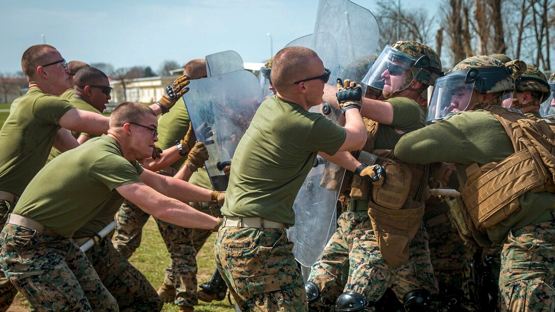 Marines with shields fight against other Marines.